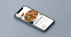 iphone 8 against gray background with recipe for kung pao chicken on screen