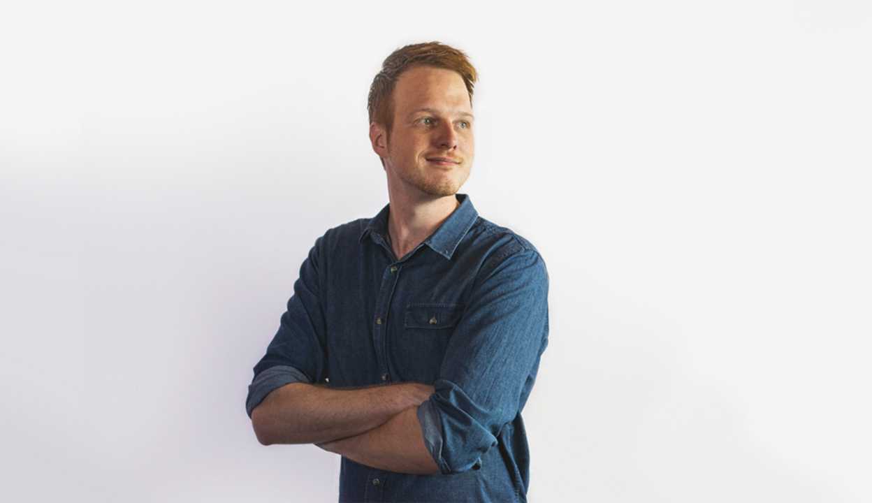 man in collared shirt against white background